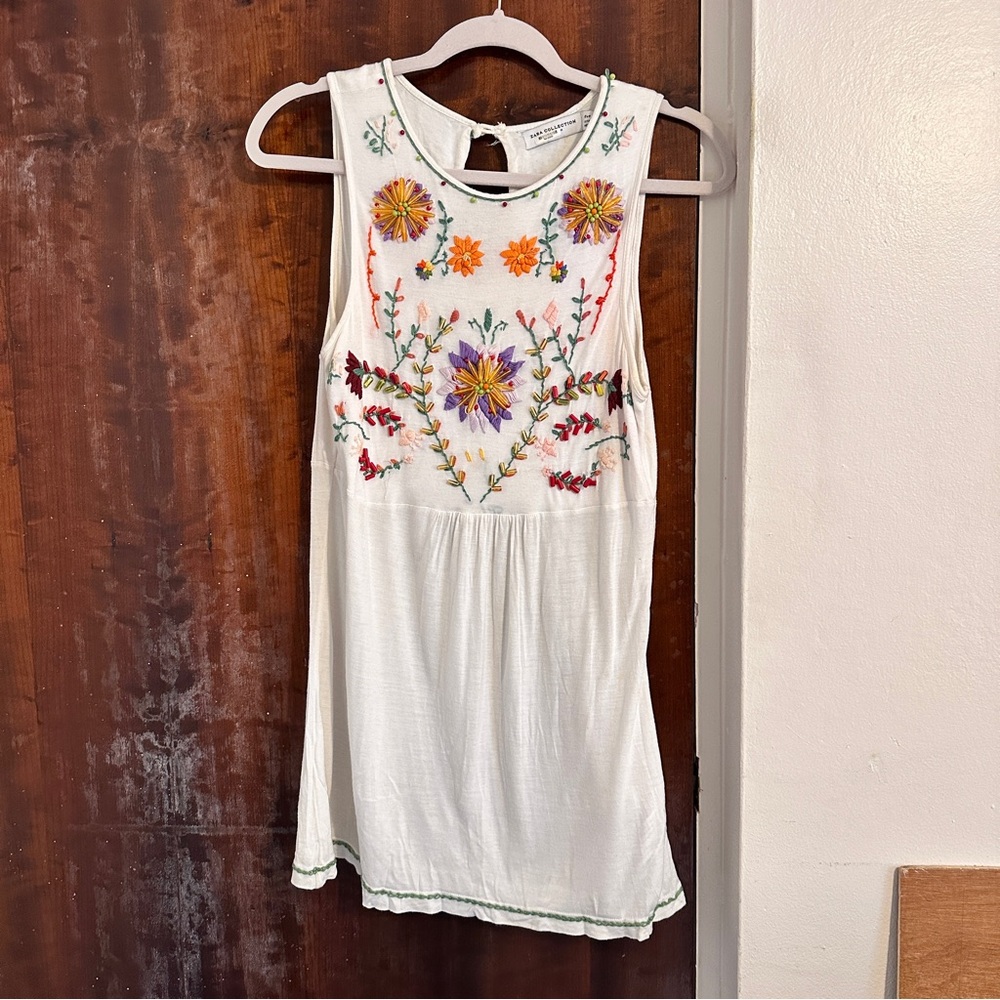 Embroidered white top.